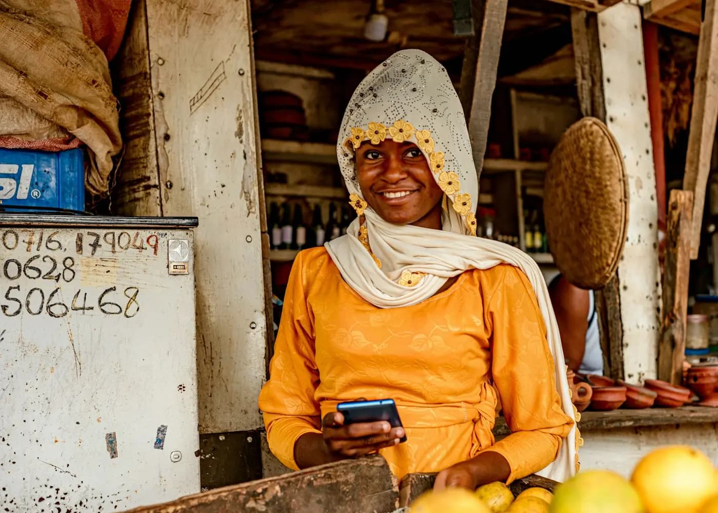 A market trader checking a payment on her phone